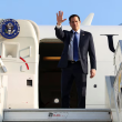 U.S. Secretary of State Marco Rubio waves at reporters as he disembarks from a plane in Tel Aviv.