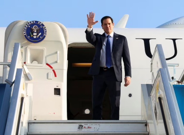 U.S. Secretary of State Marco Rubio waves at reporters as he disembarks from a plane in Tel Aviv.